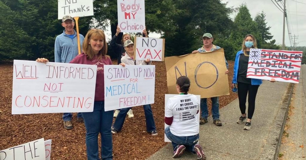 Healthcare workers and community members protest vaccine mandates.
